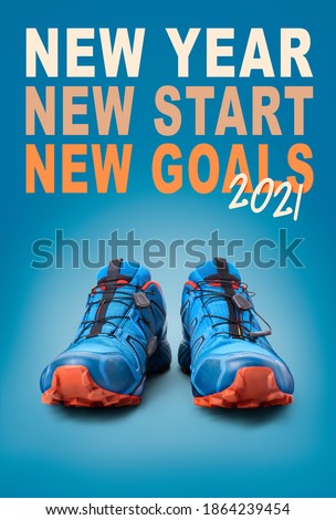 New year, new start business and health resolution concept for 2021. Front view of blue trainers on a blue background.