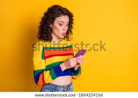 Photo of charming nice brunette hair young lady blow kiss to telephone wear short pullover isolated on bright yellow background
