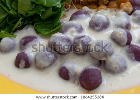 Purple sweet potato gnocchi with gorgonzola cheese sauce. Dinner time. Gastronomy. Cooking. Art. Cuisine. Natural and organic food.Gluten free.