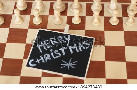 Merry Christmas hand drawn. Black background. Great top view. Chess Board. Chess pieces on board. Gift cards
