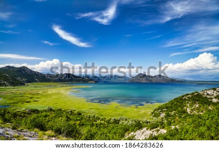 Montenegro Skadar Lake beautiful scenic coast national park panorama. Blue sky water reflection sunny outdoor Mediterranean summer wonderland background. European tourism vacation concept