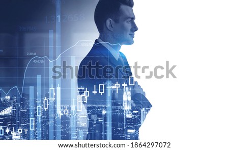 Side view of confident young businessman standing in blurry office with double exposure of graphs. Toned image