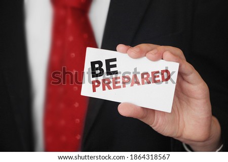 BE PREPARED, message on business card shown by a businessman. Business risk management concept.