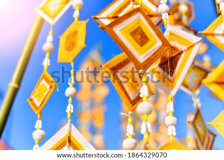 Hanging handmade hexagonal colorful knitting yarn flags suspended from bamboo pole for decoration and celebrating. Colorful drape, Blown in the traditional Buddhist beliefs. In Thailand, Myanmar, Laos