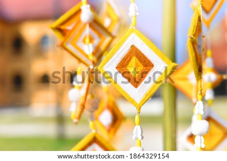 Hanging handmade hexagonal colorful knitting yarn flags suspended from bamboo pole for decoration and celebrating. Colorful drape, Blown in the traditional Buddhist beliefs. In Thailand, Myanmar, Laos