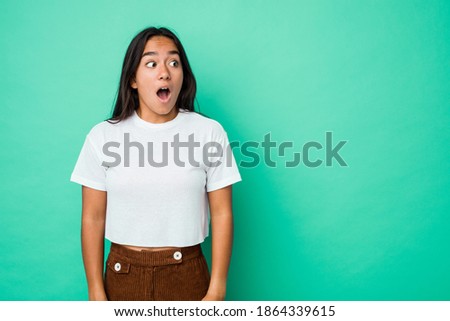 Young mixed race indian woman isolated being shocked because of something she has seen. Royalty-Free Stock Photo #1864339615