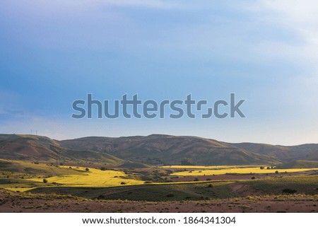 Landscape of the countryside at sunset. Hills and agricultural fields on the scene. Beautiful clouds on the sky. High quality photo