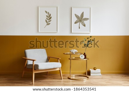 Unique living room in modern style interior with design armchair, elegant gold coffee table, mock up poster frames, flowers in vase, decoration and pesronal accessories in home decor. Template.