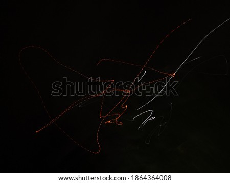 Abstract orange and white  light painting photography in black background