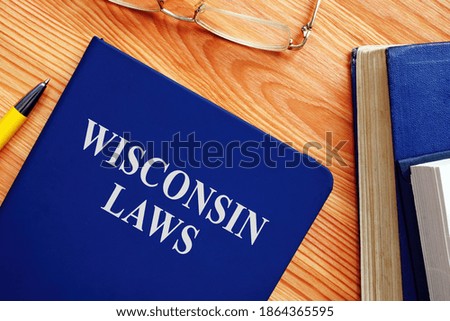 Book with State Wisconsin law on the table.