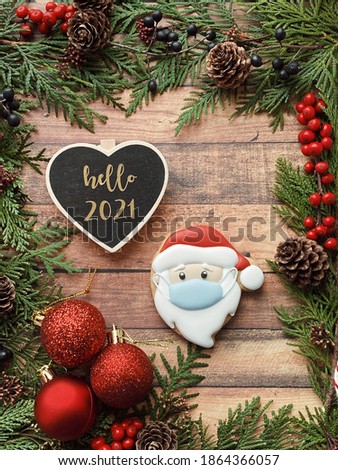 Happy new year 2021. Special Christmas 2021. Rustic winter decorations with a chalkboard for your logo and text and a Santa in a protective mask