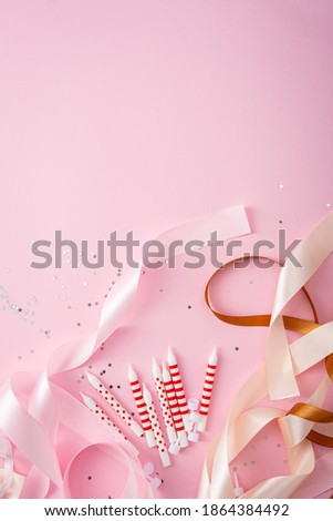 Creative pink holiday concept with candles and bow