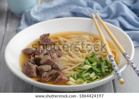 Chinese beef shank noodle soup with green onion