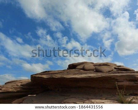 The image of the rocky cliffs, the sky is bright and white.