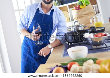 Portrait of handsome man filming cooking show or blog