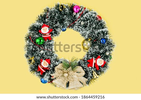 Christmas wreath on yellow background. High quality photo