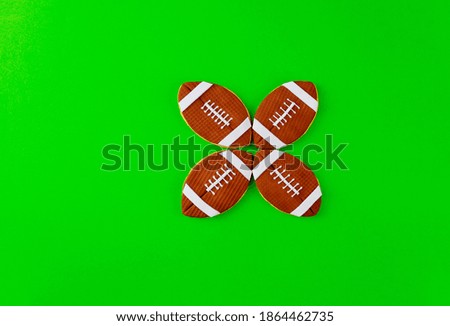 Green background with football balls cookies. Top view.