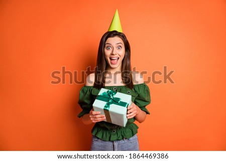 Photo of impressed lady wear green off-shoulders blouse birthday hat getting birthday gift isolated orange color background