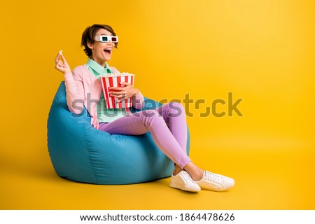 Full length body size photo woman 3d glasses watching television laughing isolated on vivid yellow color background looking at blank space