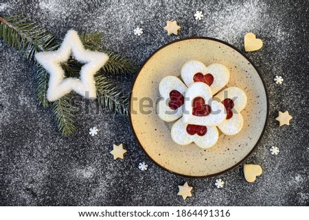 Heart shaped linzer cookies filled with strawberry jam, with romantic festive Christmas decoration