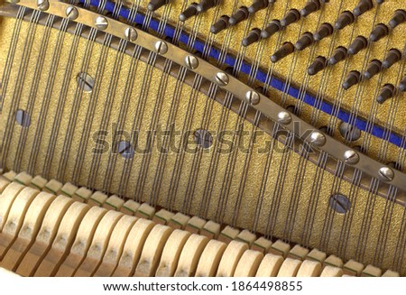 View inside the old piano. Musical instrument strings.