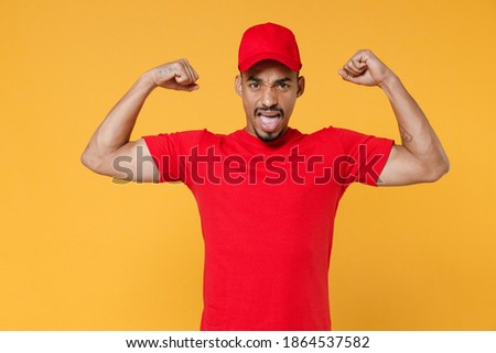 Delivery employee african man in red cap blank print t-shirt uniform workwear work courier service on quarantine covid-19 virus concept isolated on yellow background studio. Tattoo translation life