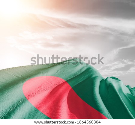 Bangladesh national flag cloth fabric waving on beautiful sky background.