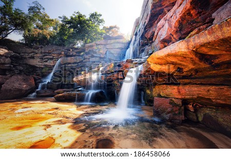 Waterfall and mountain landscape. Fresh water river stream flowing through beautiful rocky canyon. Nature photography 