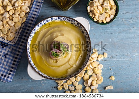 Taditional fava with olive oil. Mashed broad beans fava appetizer. Top view. Royalty-Free Stock Photo #1864586734