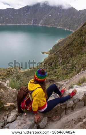 
girl travel photographer in spectacular landscape lagoon inside volcano with mist quilotoa ecuador latin america