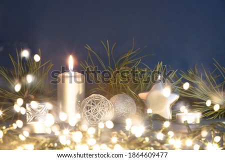Magic holiday blue background with christmas decorations, gift box and candle.