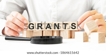Businessman holding wooden cubes. Businessman watch on the wooden cubes with text unpaid. financial market. financing