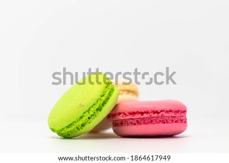 Macaroons isolated on the white background.Homemade french style colorful macaroons. Green, white, pink cookies
