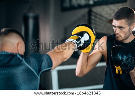 two muscle boxers sport man training and fighting on boxing ring at gym Royalty-Free Stock Photo #1864621345