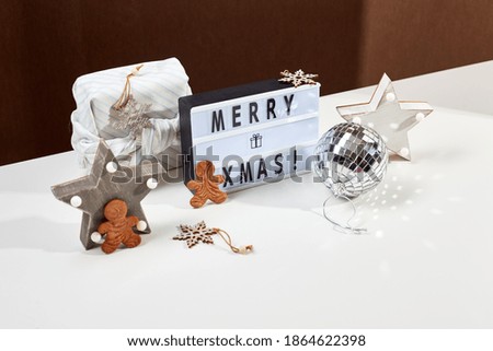 New Year or Christmas composition. Light box inscription Merry Xmas and wooden ornaments, copy space.