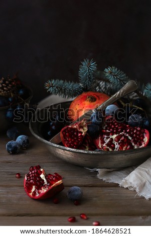 Pomagranate and Graps On Rustic Background