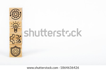 Business strategy symbols and engineering concept on wooden cubes.
