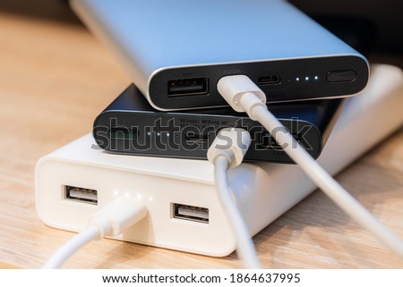 Portable  power banks in a charger process.   Royalty-Free Stock Photo #1864637995