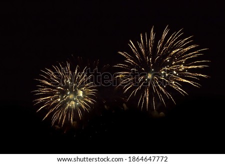 Beautiful yellow firework isolated closeup on black background. Firework explode night. Template to design Greeting card for Christmas holidays, New year, independence day, Birthday