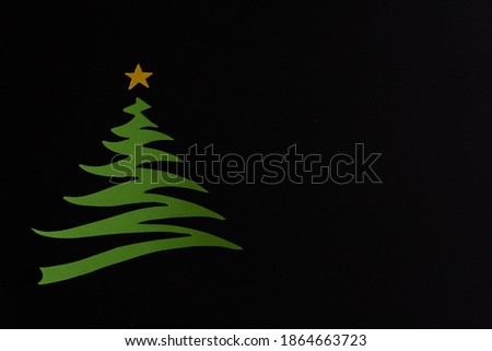 Paper cut green Christmas tree on black background. Blank Christmas card.