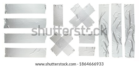 Set of different size silver grey adhesive tape on white background. Torn and crumpled pieces of grey sticky duct tape. Royalty-Free Stock Photo #1864666933