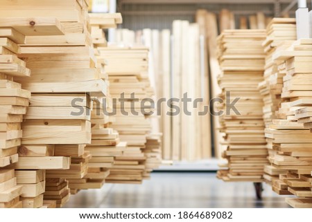 stacked wooden boards in a woodworking industry. stacks with pine lumber. folded edged board. wood harvesting shop. timber for construction Royalty-Free Stock Photo #1864689082