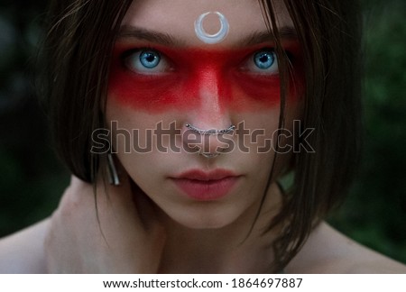Portrait of an Indian woman with red coloring and the Moon
