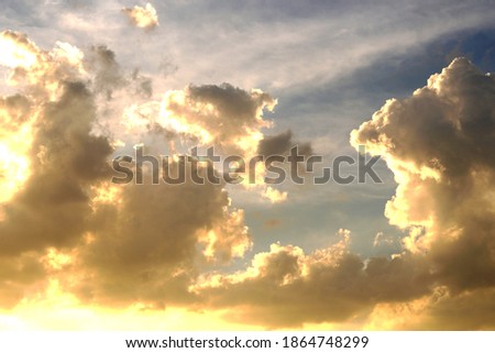 Shining sun with clouds in the sky background.