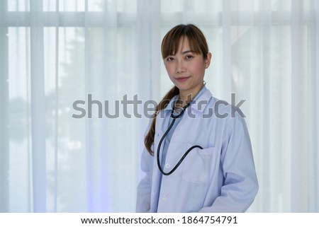 Smiling female doctor in white coat with Medical stethoscope. Portrait beautiful young Asian Medical physician doctor.