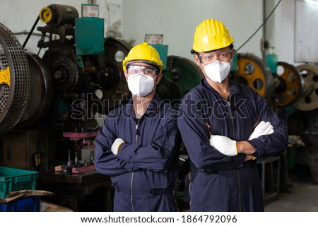portrait crossed arms post two male engineer man or factory worker wearing helmet and face mask for protect virus