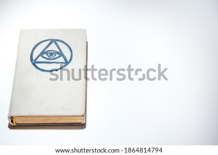 Occult grimoire, white magic book on white background, ritual, altar, spiritism, secret knowledge tone. Empty copy space.