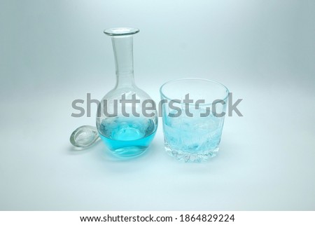 blue alcoholic drink in a decanter. Cocktail with blue gin on a white background