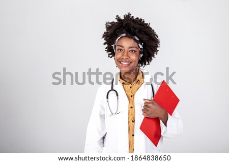 Happy african american female doctor holding medical chart over white background, copy space.
