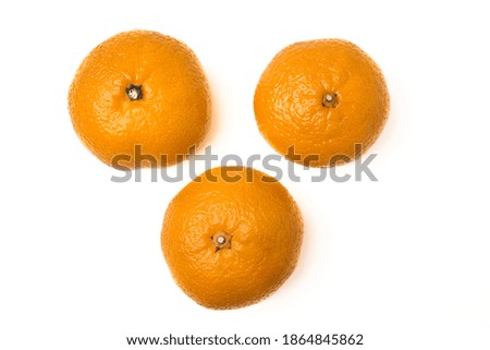Three juicy tangerines lined up in a triangle. Isolated on a white background. Top view.